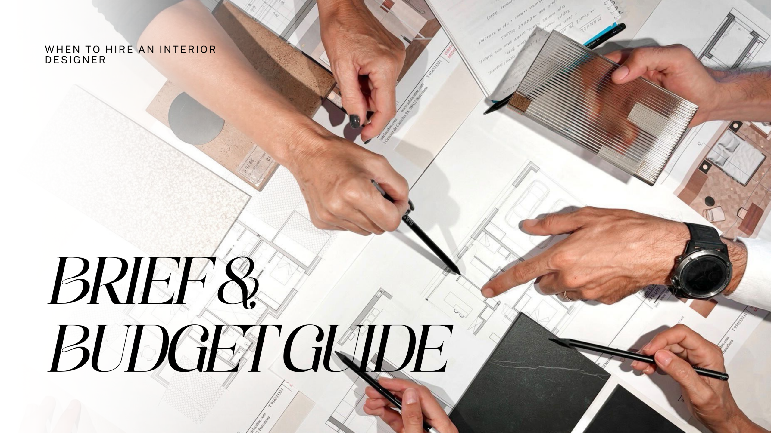 Interior designers meeting to review architectural floor plans, material samples, and budget guides for a client project.